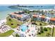 Aerial view of the condo complex, showing the pool, surrounding greenery, and waterfront location at 825 S Gulfview Blvd # 202, Clearwater Beach, FL 33767