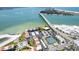 Aerial view showcasing the community, access to the beach, and the nearby bridge with clear, turquoise waters at 825 S Gulfview Blvd # 202, Clearwater Beach, FL 33767