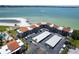 Aerial view of a condo complex with beach access and beautiful ocean views on a sunny day at 825 S Gulfview Blvd # 202, Clearwater Beach, FL 33767