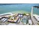 Aerial view of beachfront community, showcasing the beach, tennis courts, pool and easy access to the bridge at 825 S Gulfview Blvd # 202, Clearwater Beach, FL 33767