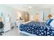 Bedroom with white furnishings, coastal decor, and a queen-size bed with bedside tables at 825 S Gulfview Blvd # 202, Clearwater Beach, FL 33767