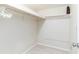 A walk-in closet with white walls, light-colored floors, and ample storage space for clothing at 825 S Gulfview Blvd # 202, Clearwater Beach, FL 33767