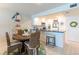 Open dining area with seating for four, seamlessly connected to the kitchen featuring a breakfast bar at 825 S Gulfview Blvd # 202, Clearwater Beach, FL 33767