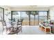 Dining area with water views, glass top table and black metal chairs at 825 S Gulfview Blvd # 202, Clearwater Beach, FL 33767