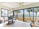 Cozy dining area featuring glass table and water views through the sliding glass doors at 825 S Gulfview Blvd # 202, Clearwater Beach, FL 33767