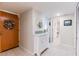 Inviting entryway featuring a decorative wreath, white storage cabinet, and access to the bathroom at 825 S Gulfview Blvd # 202, Clearwater Beach, FL 33767