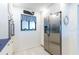 Well-lit kitchen featuring stainless steel refrigerator, white cabinets, and blue accents at 825 S Gulfview Blvd # 202, Clearwater Beach, FL 33767