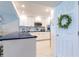 Well-lit kitchen features white cabinets, modern appliances, and a blue countertop island with barstool seating at 825 S Gulfview Blvd # 202, Clearwater Beach, FL 33767