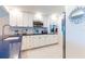 Modern kitchen with white cabinetry, stainless steel appliances, dark countertops, and ample counter space at 825 S Gulfview Blvd # 202, Clearwater Beach, FL 33767