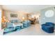 Comfortable living room with stylish furnishings and a view into the adjacent kitchen area at 825 S Gulfview Blvd # 202, Clearwater Beach, FL 33767