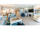 Comfortable living room with coastal-themed decor and an open floor plan, featuring a fireplace and built-in shelving at 825 S Gulfview Blvd # 202, Clearwater Beach, FL 33767