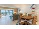 Living room with ocean view, coastal decor, and a dining table with seating for four at 825 S Gulfview Blvd # 202, Clearwater Beach, FL 33767