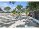 Expansive backyard featuring a pool, patio area, screened-in porch, and manicured landscaping at 8302 W Pocahontas Ave, Tampa, FL 33615