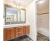 Modern bathroom with a sleek double vanity, mosaic tile backsplash, and a combined tub and shower at 8302 W Pocahontas Ave, Tampa, FL 33615