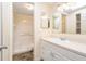 Bathroom features a single sink vanity with drawers and cabinets, and a shower at 8302 W Pocahontas Ave, Tampa, FL 33615