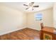 Bedroom features hardwood floors, a ceiling fan, and natural light, complete with furniture at 8302 W Pocahontas Ave, Tampa, FL 33615