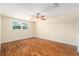 Bedroom with warm lighting, ceiling fan and window at 8302 W Pocahontas Ave, Tampa, FL 33615
