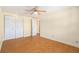 Bedroom features hardwood floors, a ceiling fan, and natural light, with closet and doorways at 8302 W Pocahontas Ave, Tampa, FL 33615