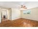 Spacious bedroom with hardwood floors, ceiling fan, and bright natural light from the window at 8302 W Pocahontas Ave, Tampa, FL 33615