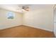 Bedroom features hardwood floors, a ceiling fan, and natural light, with a closet at 8302 W Pocahontas Ave, Tampa, FL 33615