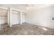 Bright bedroom featuring two closets and gray wood-look tile flooring at 8302 W Pocahontas Ave, Tampa, FL 33615