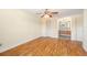 Bedroom with wood flooring, ceiling fan, and adjoining bathroom at 8302 W Pocahontas Ave, Tampa, FL 33615