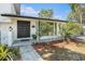 Inviting front entrance with well-manicured landscaping and a covered porch at 8302 W Pocahontas Ave, Tampa, FL 33615