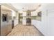 Bright kitchen featuring stainless steel appliances and white cabinetry providing a modern aesthetic at 8302 W Pocahontas Ave, Tampa, FL 33615