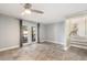 Living Room with wood-look tile flooring, ceiling fan, and glass patio doors at 8302 W Pocahontas Ave, Tampa, FL 33615