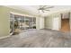 Bright and airy living room boasts a large window, tile floors, and staircase access at 8302 W Pocahontas Ave, Tampa, FL 33615