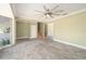 Open living area features tile flooring, staircase, and a large picture window at 8302 W Pocahontas Ave, Tampa, FL 33615