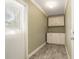 Hallway with white storage cabinets and olive colored walls at 8302 W Pocahontas Ave, Tampa, FL 33615