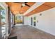 Enclosed sunroom featuring large windows, ceiling fans, and an exit to a patio at 8302 W Pocahontas Ave, Tampa, FL 33615