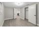 Bedroom with an open closet and gray wood-look laminate flooring at 9135 Suffolk Ln, Port Richey, FL 34668