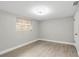 Bedroom featuring wood-look flooring, light gray walls, and a window at 9135 Suffolk Ln, Port Richey, FL 34668