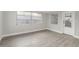 Bright bedroom with laminate floors and a glass-paneled door at 9135 Suffolk Ln, Port Richey, FL 34668