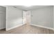 Bedroom featuring wood-look flooring, light gray walls, and an open doorway at 9135 Suffolk Ln, Port Richey, FL 34668