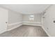 Bedroom featuring wood-look flooring, light gray walls, and windows at 9135 Suffolk Ln, Port Richey, FL 34668