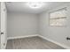 Bright bedroom featuring light gray walls and wood-look laminate flooring at 9135 Suffolk Ln, Port Richey, FL 34668