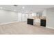 Spacious kitchen featuring modern white cabinets, a butcher block island, and sleek laminate flooring at 9135 Suffolk Ln, Port Richey, FL 34668