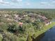 Aerial view of a residential community with lush landscaping, a lake, and beautiful red-tiled roofs at 9481 Highland Oak Dr Dr # 508, Tampa, FL 33647