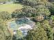 Aerial view of community's basketball court, beach volleyball court, and other amenities surrounded by lush green trees and grass at 9481 Highland Oak Dr Dr # 508, Tampa, FL 33647