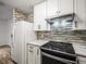 Bright kitchen with stainless steel appliances, granite countertops, and a modern backsplash for a sleek look at 9481 Highland Oak Dr Dr # 508, Tampa, FL 33647