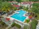 Aerial view of community pool featuring lounge chairs and umbrellas at 9481 Highland Oak Dr Dr # 508, Tampa, FL 33647