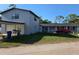Charming two-story home with a front yard and a red car parked in front of the house at 9950 Morris Bridge, Tampa, FL 33637