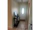 Inviting foyer with neutral tile flooring, a console table, and a front door with an oval window at 9950 Morris Bridge, Tampa, FL 33637