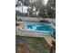Backyard featuring a beautiful in-ground pool, lush green landscaping and a white fence at 9950 Morris Bridge, Tampa, FL 33637