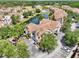 Aerial view of residential homes surrounding a pond with lush, green trees at 10434 Villa View Cir, Tampa, FL 33647