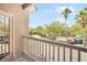 Balcony with railing overlooking a parking lot with views of lush greenery at 10434 Villa View Cir, Tampa, FL 33647