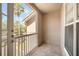 Cozy condo balcony with tiled floor and a view of the palm trees at 10434 Villa View Cir, Tampa, FL 33647